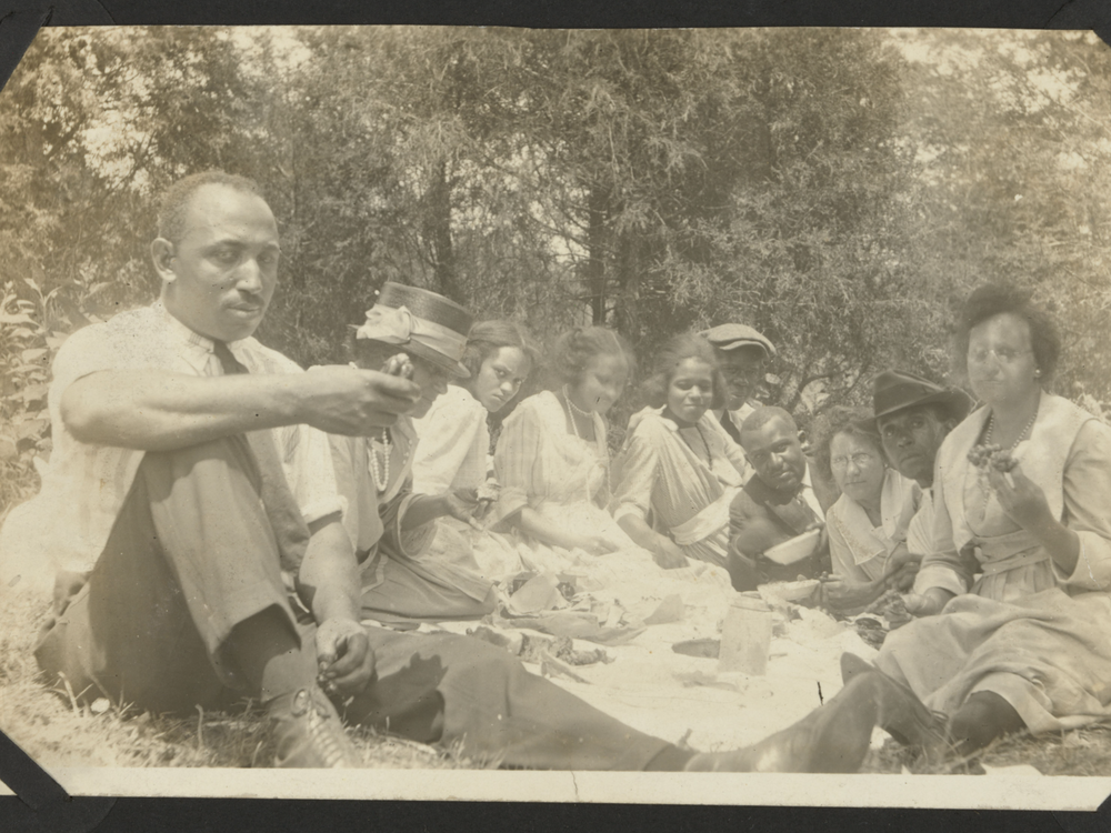 Group of people having a picnic in the 1920s