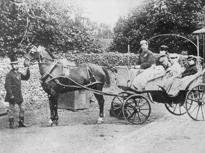 Author Charles Dickens (1812-1870) pictured with his wife, Catherine Dickens (1815-1879), and two of their daughters, seated in a horsedrawn carriage, circa 1850.

