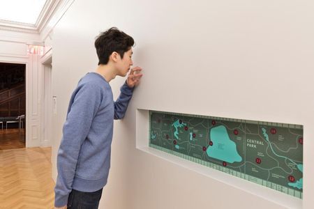 In the installation of Smell, The Beauty of Decay: SmellScape Central Park, designed by Sissel Tolaas, visitors touch the wall that has been painted with the special paint, releasing the scent.