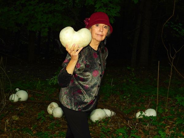 Self portrait holding heart shaped puffball mushroom thumbnail