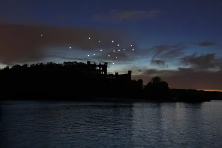A rendering of the installation, which officially launches June 28. Seventeen artist-made stars will glow each night in a constellation above an abandoned castle.