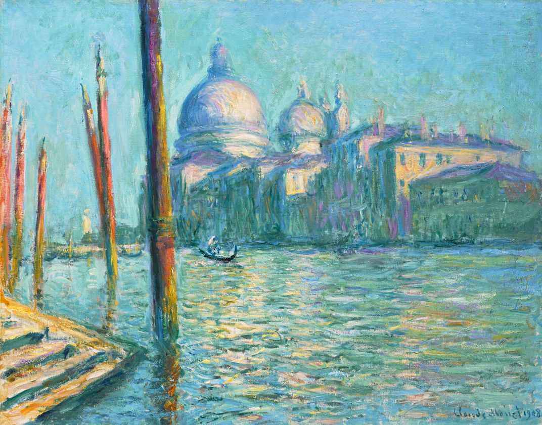 A painting by Claude Monet of water and buildings in the distance.