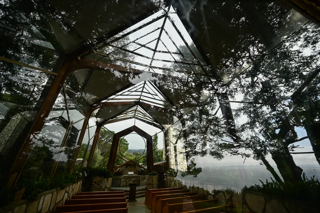 Glass-enclosed chapel with trees around it