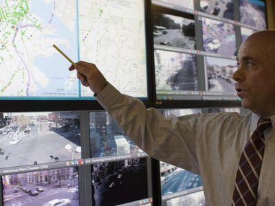 Traffic control centers like this one in Boston—a room cluttered with computer terminals and live video feeds of urban intersections—represent the brain of a traffic system. 