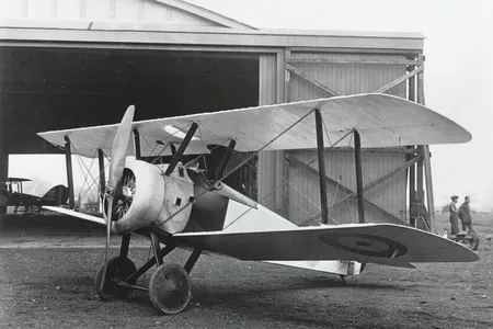 A Sopwith Camel, World War I fighter, seen outside a hangar