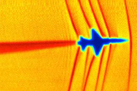 At Mach 1, shock waves coming off a T-38 (seen using Schlieren photography) will coalesce to form a mighty boom. 