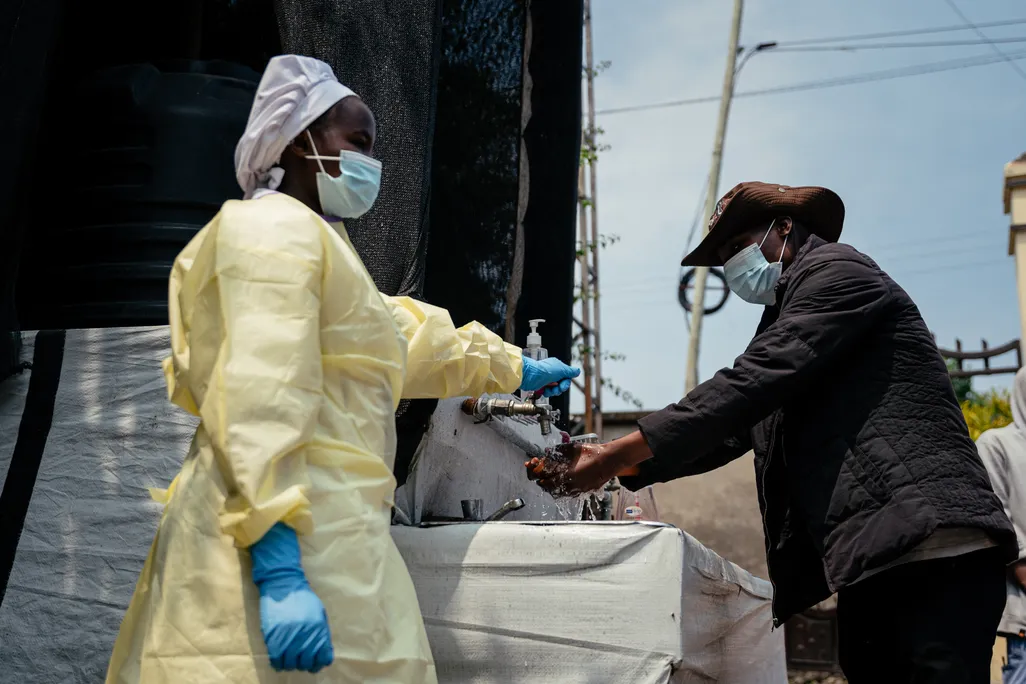 A visitor washes his hands before entering a hospital
