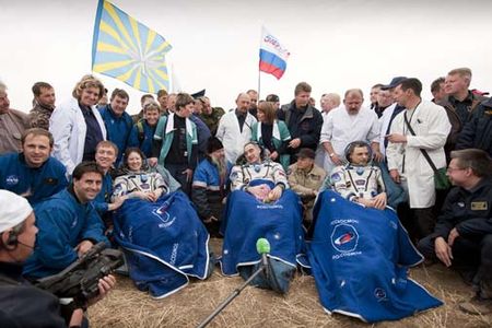 Expedition 24 Flight Engineers Tracy Caldwell Dyson, left, Commander Alexander Skvortsov, center and Mikhail Kornienko sit in chairs outside the Soyuz Capsule just minutes after they landed near the town of Arkalyk, Kazakhstan on Saturday, Sept. 25, 2010.  Russian Cosmonauts Skvortsov and Kornienko and NASA Astronaut Caldwell Dyson, are returning from six months onboard the International Space Station where they served as members of the Expedition 23 and 24 crews. Photo Credit: (NASA/Bill Ingalls)