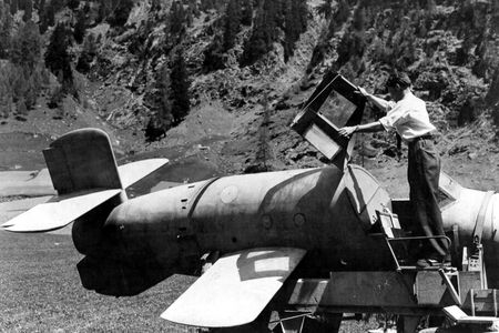 In 1945 Austria, after the German surrender, a U.S. engineer lifts the hinged canopy of a captured Bachem Ba 349 to take a look inside the cockpit.