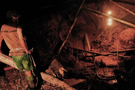 To find flecks of gold, workers devour the rainforest floor with water cannons. "There are a lot of accidents," says one. "The sides of the hole can fall away, can crush you."