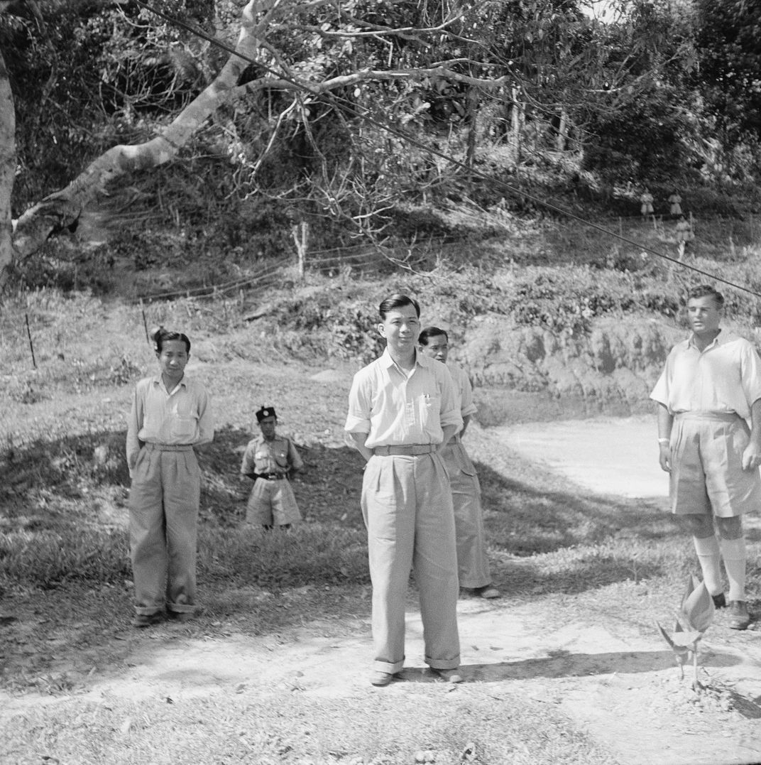Chin Peng (foreground) looks at the townlet of Bailing before returning to the jungle