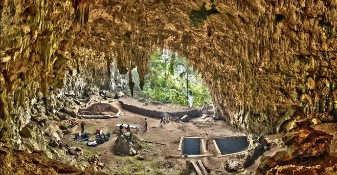 A rendering of a prehistoric cave with early humans.