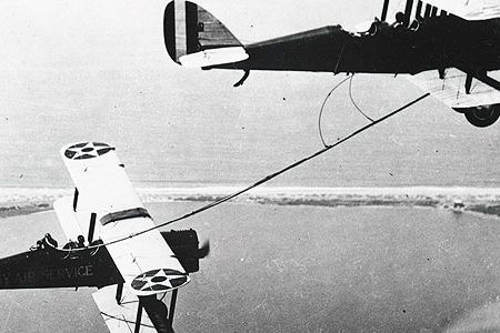 Early aerial refueling required catching the hose by hand, as the back-seater in the de Havilland DH-4B (left) did in 1923.