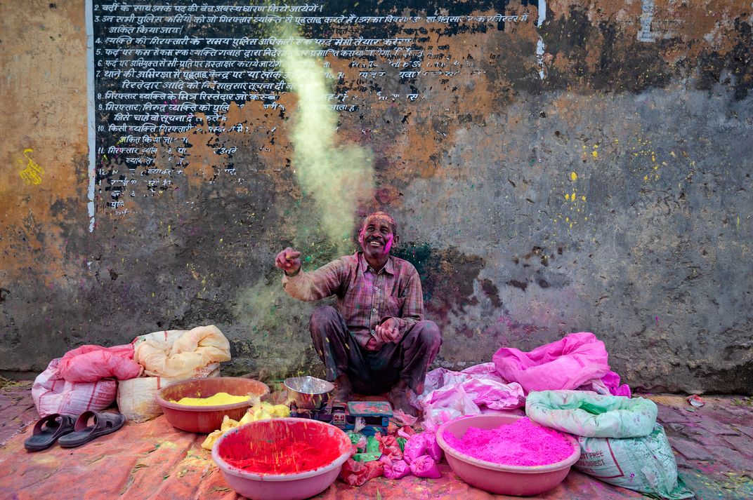 a merchant selling colorful pigment for Holi Festival in India