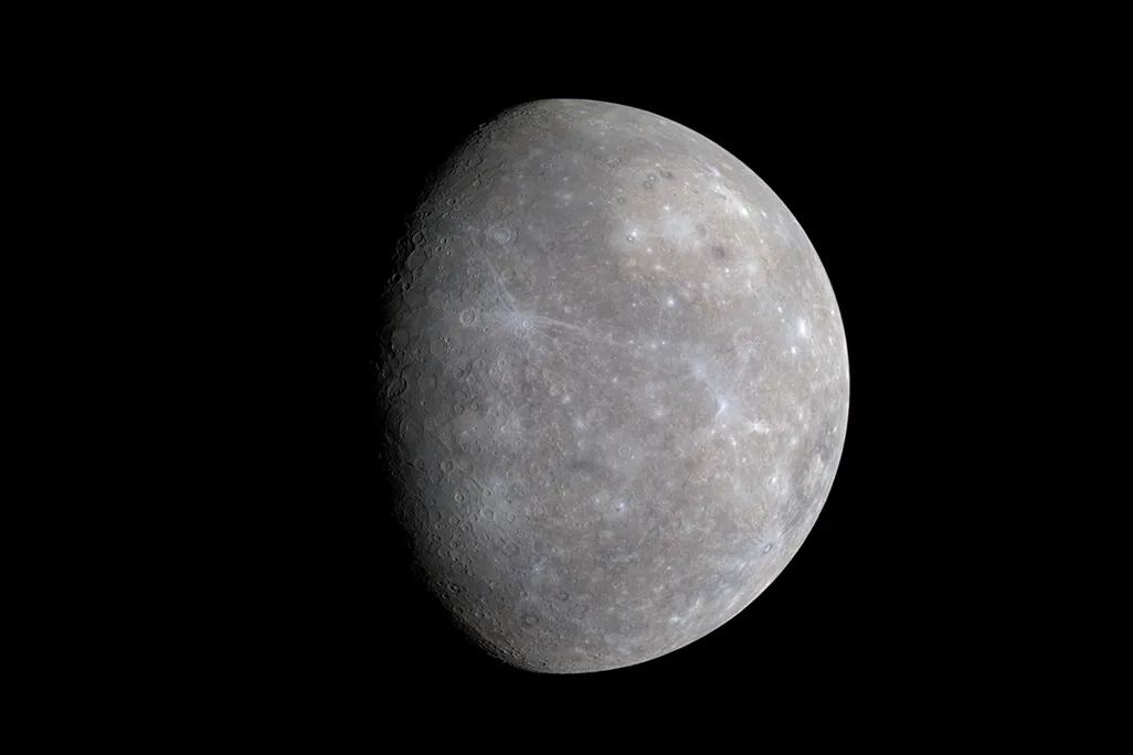 An image of planet Mercury showing its cratered surface and sublte color