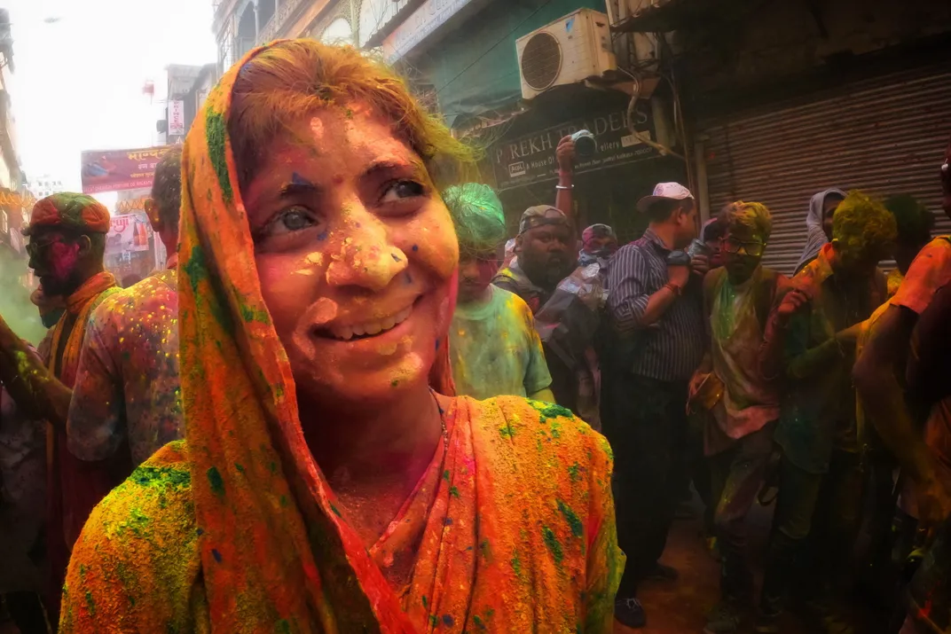a woman celebrates Holi Festival in India