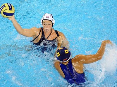 Natalie Golda looks to pass the ball during a preliminary round water polo match at the 2008 Summer Olympics in Beijing.