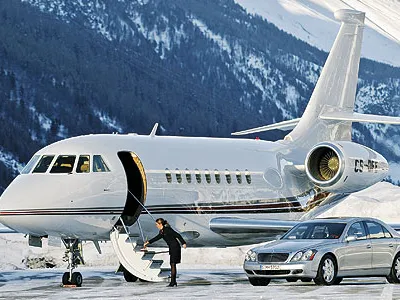 A Dassault Falcon 2000, a Maybach luxury auto, and freshly swept stairs: NetJets set up this publicity shot in Switzerland, but for fractional jet owners, such fantasy is the reality.