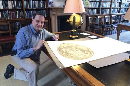The author in the library of the Royal Astronomical Society in London with Cassini’s 1679 map of the Moon.