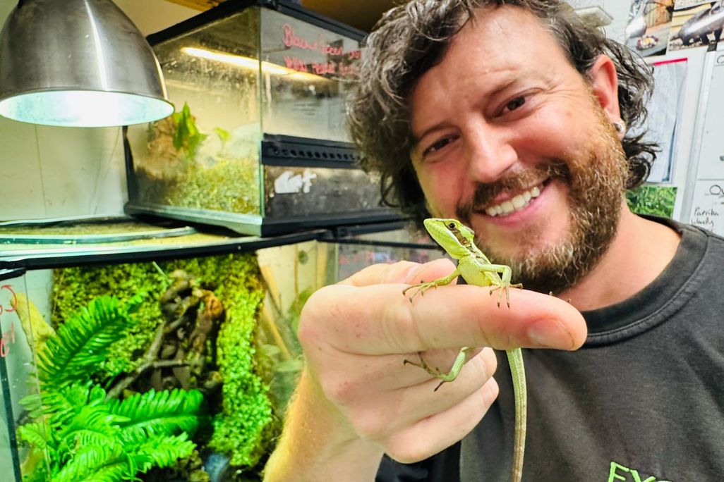 Exotic Zoo director Scott Adams holding an iguana
