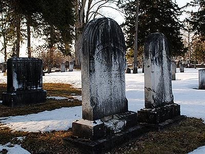 The region's legacy of acid rain is clearly visible in the black crust on the gravestones at the Madison Street Cemetery in Hamilton, New York.