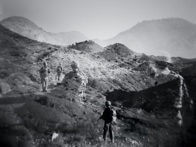 A patrol returns to Forward Operating Base Tillman, in eastern Afghanistan. It was closed in 2012, the year after this double exposure was made.