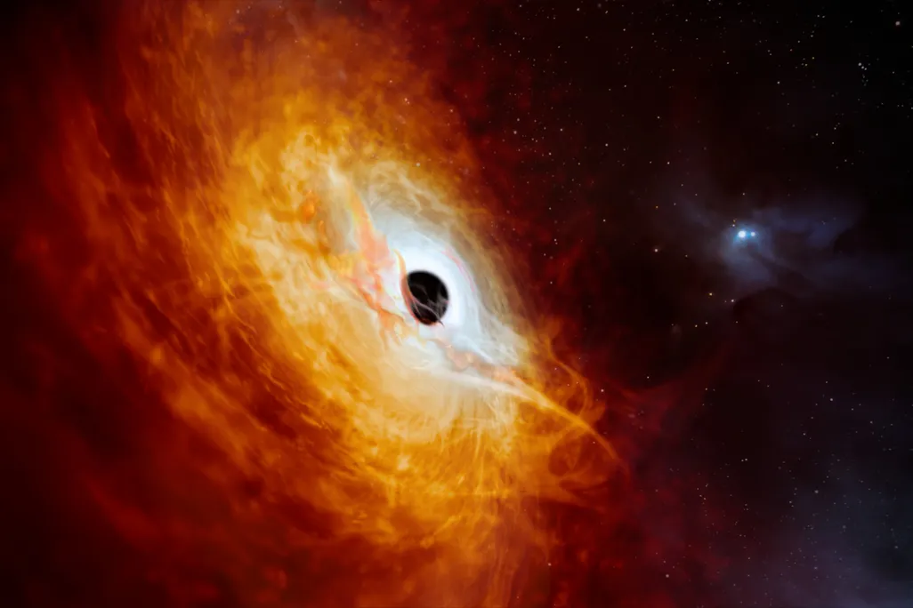 An artist's rendering of a fiery galactic core swirling around a black hole at its cennter
