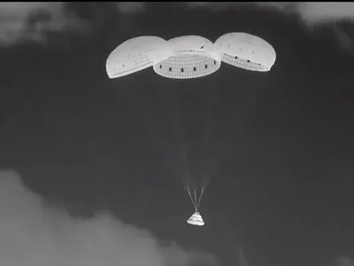 Boeing Starliner's capsule Calypso deploys parachutes during its descent toward Earth late at night on September 6.