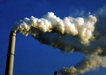 Clouds of smoke pour from a smokestack