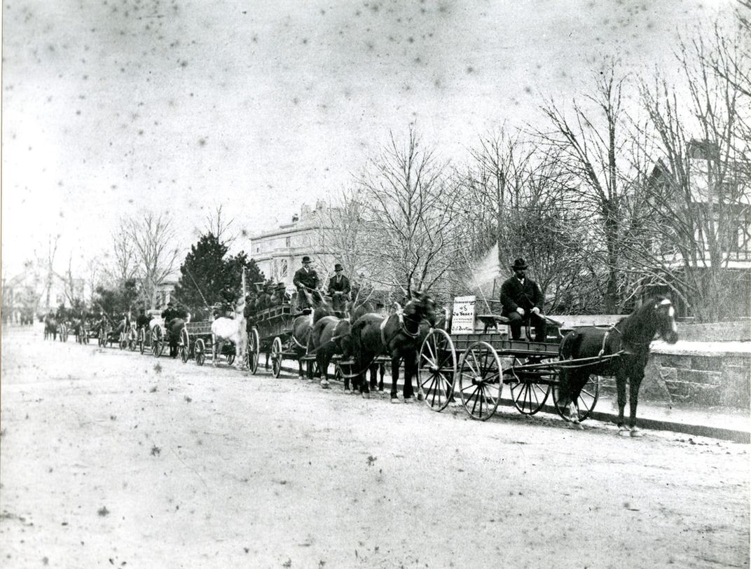 Benjamin J. Burton’s carriage business holds a 20th anniversary parade on the streets of Newport in 1875.