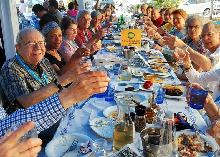 Smithsonian Journeys Travelers enjoying a meal in Greece on our Athens and Poros Tour.