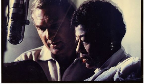 Norman Granz and Ella Fitzgerald at a microphone, 1950. (Ella Fitzerald Papers, NMAH Archives Center)