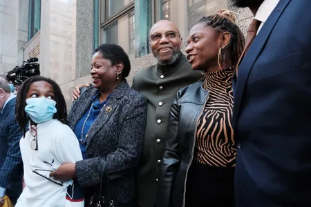 Muhammad Aziz (center) stands outside of a New York City courthouse with members of his family and lawyers on November 18, 2021.
