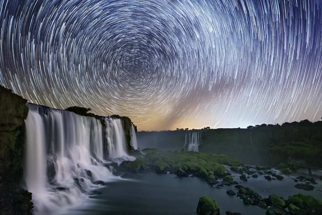 waterfalls under a starry nigh sky