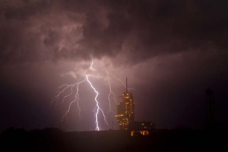 The space shuttle Endeavour is seen on launch pad 39a as a storm passes by prior to the rollback of the Rotating Service Structure (RSS), Thursday, April 28, 2011, at Kennedy Space Center in Cape Canaveral, Fla. During the 14-day mission, Endeavour and the STS-134 crew will deliver the Alpha Magnetic Spectrometer (AMS) and spare parts including two S-band communications antennas, a high-pressure gas tank and additional spare parts for Dextre. Launch is targeted for Friday, April 29 at 3:47 p.m. EDT.  Photo credit: (NASA/Bill Ingalls)d