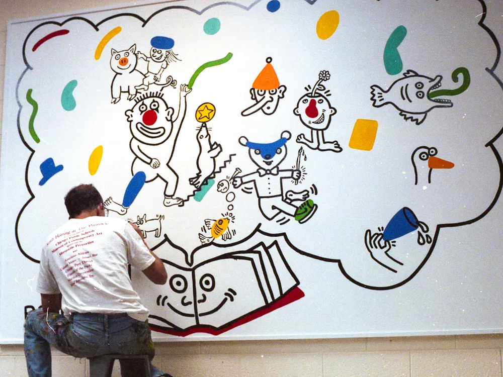 Keith Haring at work on the mural at Ernest Horn Elementary School