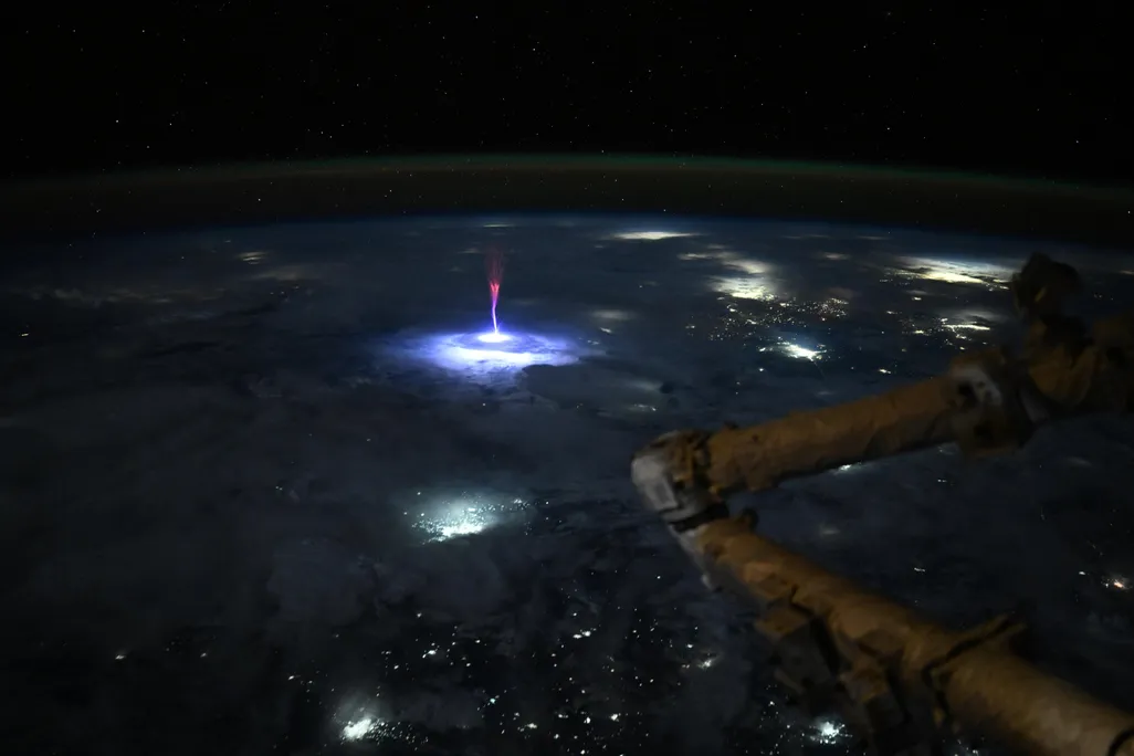 a red flash of light above clouds
