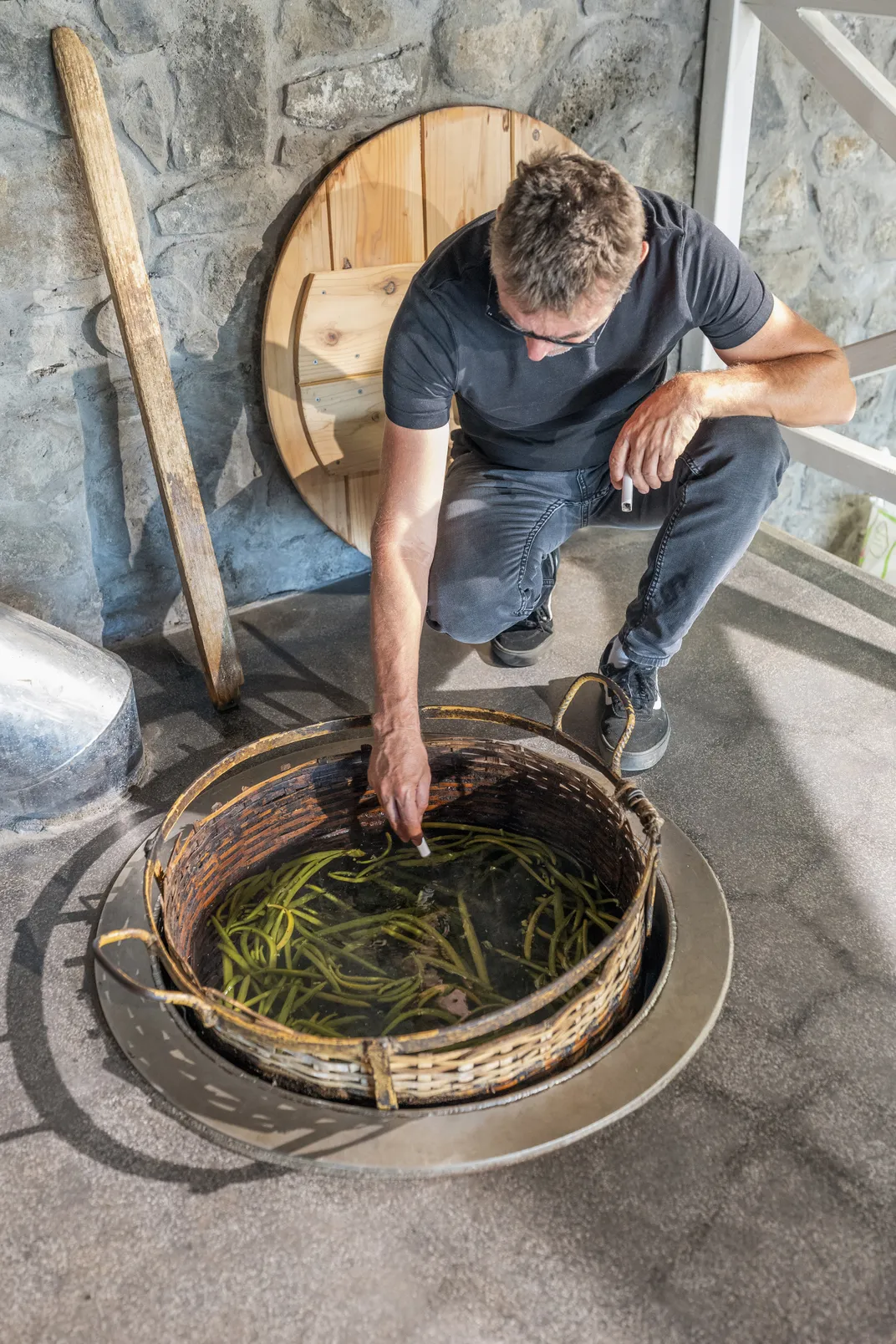 Côme demonstrates the method of échaudage, or scalding the green vanilla beans, immersing them in 145-degree water for three minutes, which prevents them from opening.