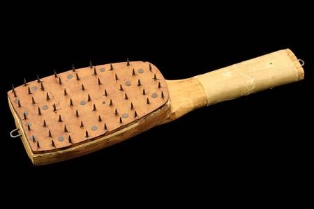 A wooden paddle with a nail-studded leather face was used in Alabama in 1899 to perforate mail in preparation for fumigation as a precaution against yellow fever.