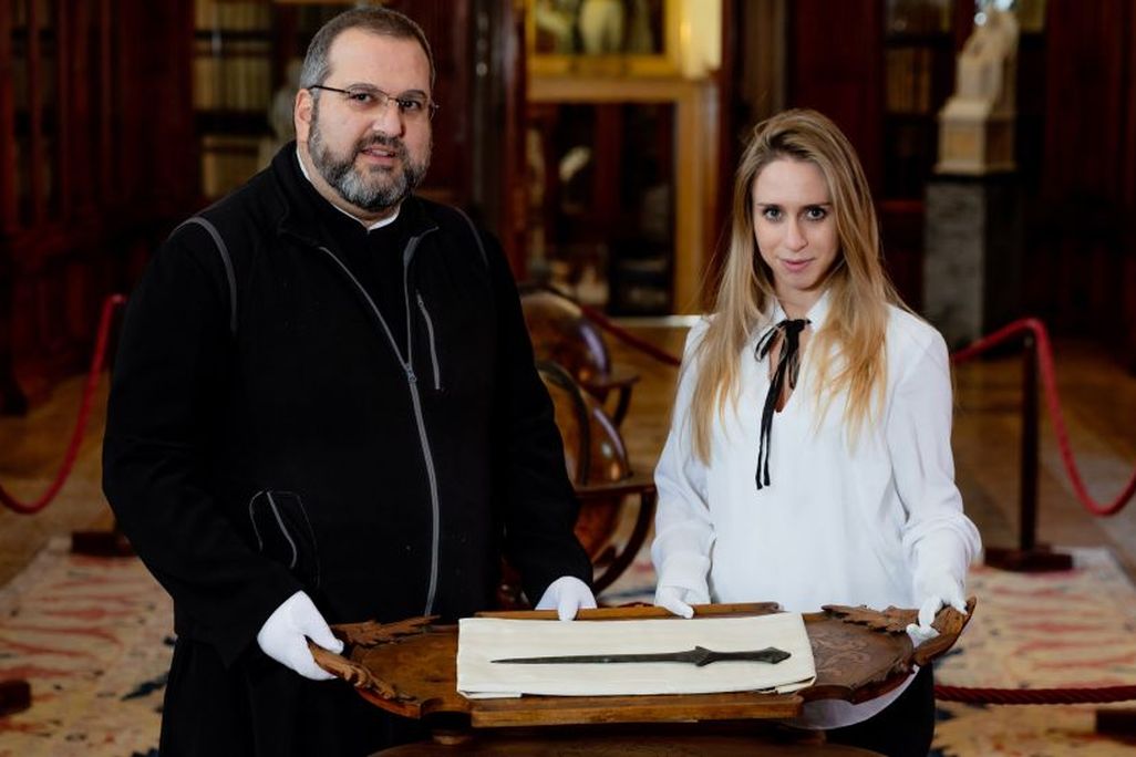 Archaeologists with sword