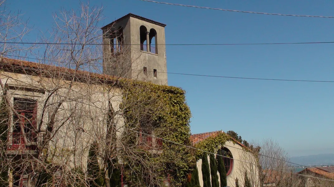 A shot of the exterior of one of the Institute's buildings, built in the Spanish mission style with a bell tower and ivy growing along the side