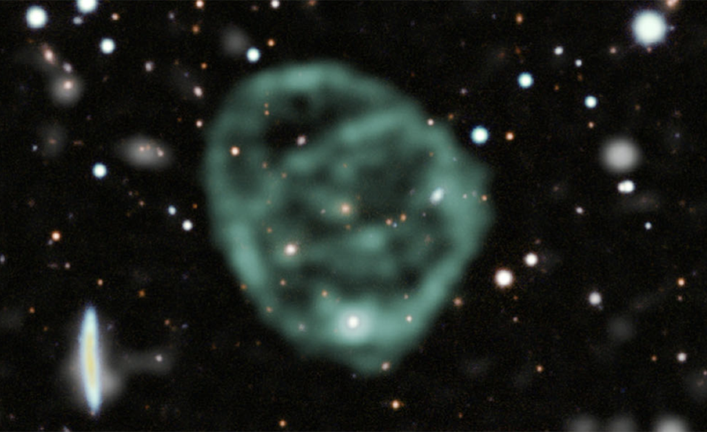 A blurry light-green circle surrounded by stars in space