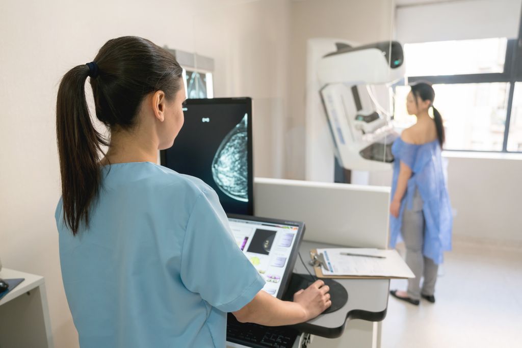 A nurse administering a mammogram