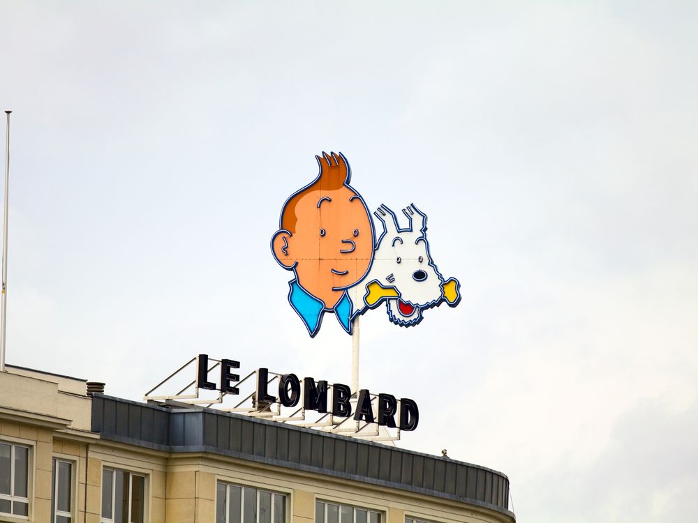 Billboard sign of young boy with orange hair and white dog