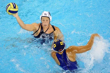 Natalie Golda looks to pass the ball during a preliminary round water polo match at the 2008 Summer Olympics in Beijing.