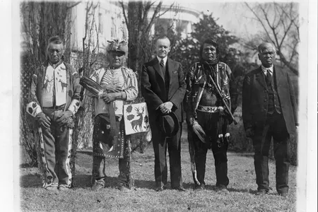 Calvin Coolidge poses with Native American leaders on the White House lawn in 1925.