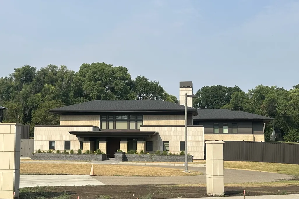 A large home with trees in the background