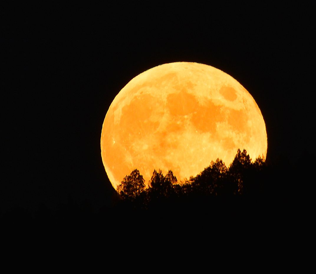 Full moon rising over the ridge of the mountain. | Smithsonian Photo ...