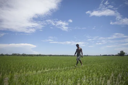 A resident walks along the border of an Indian enclave within Bangladesh