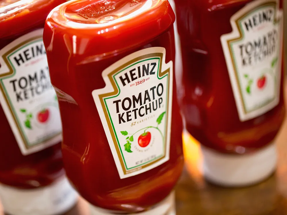three plastic bottles of Heinz tomato ketchup